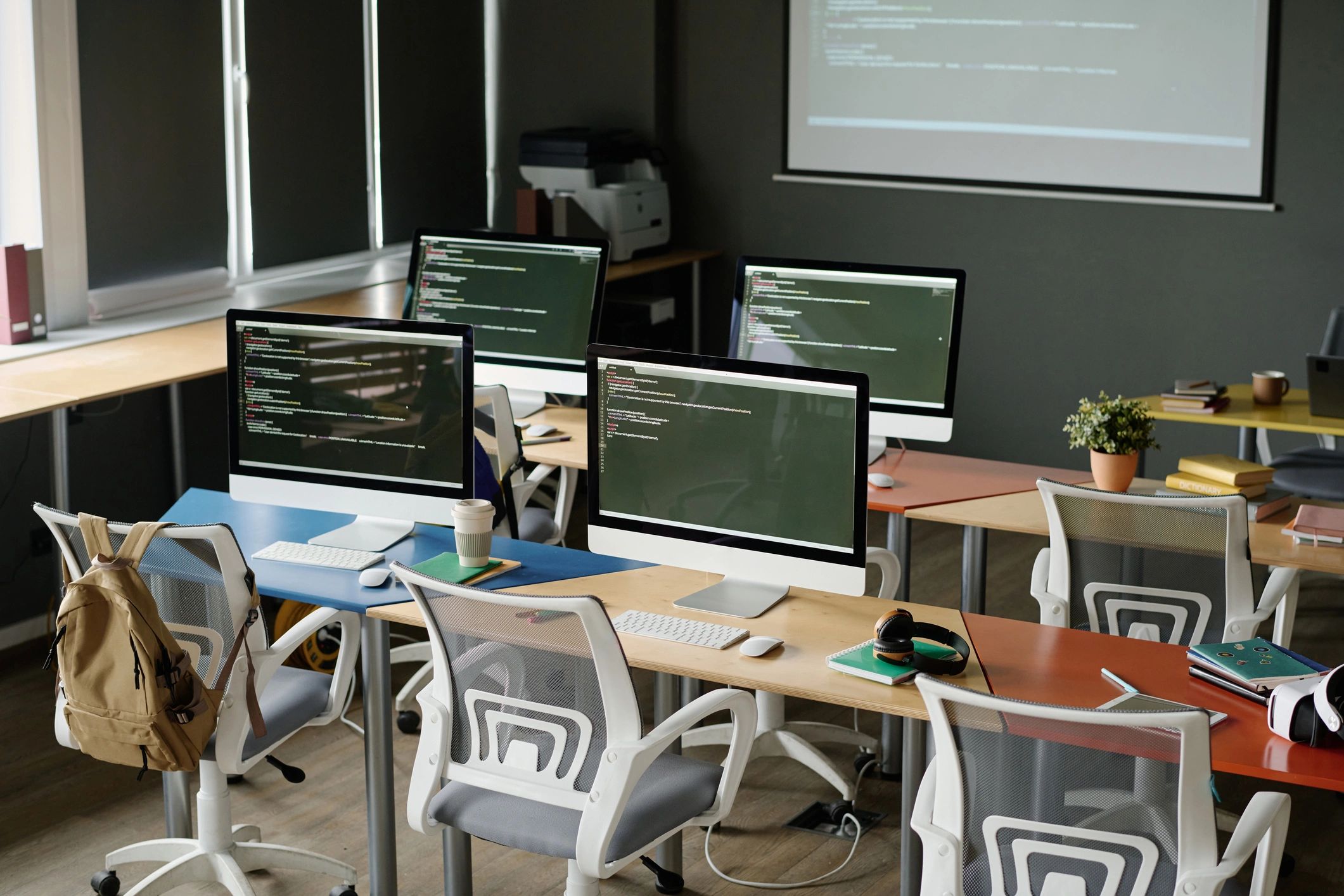 Modern computer workspace with code displayed on screen for website development