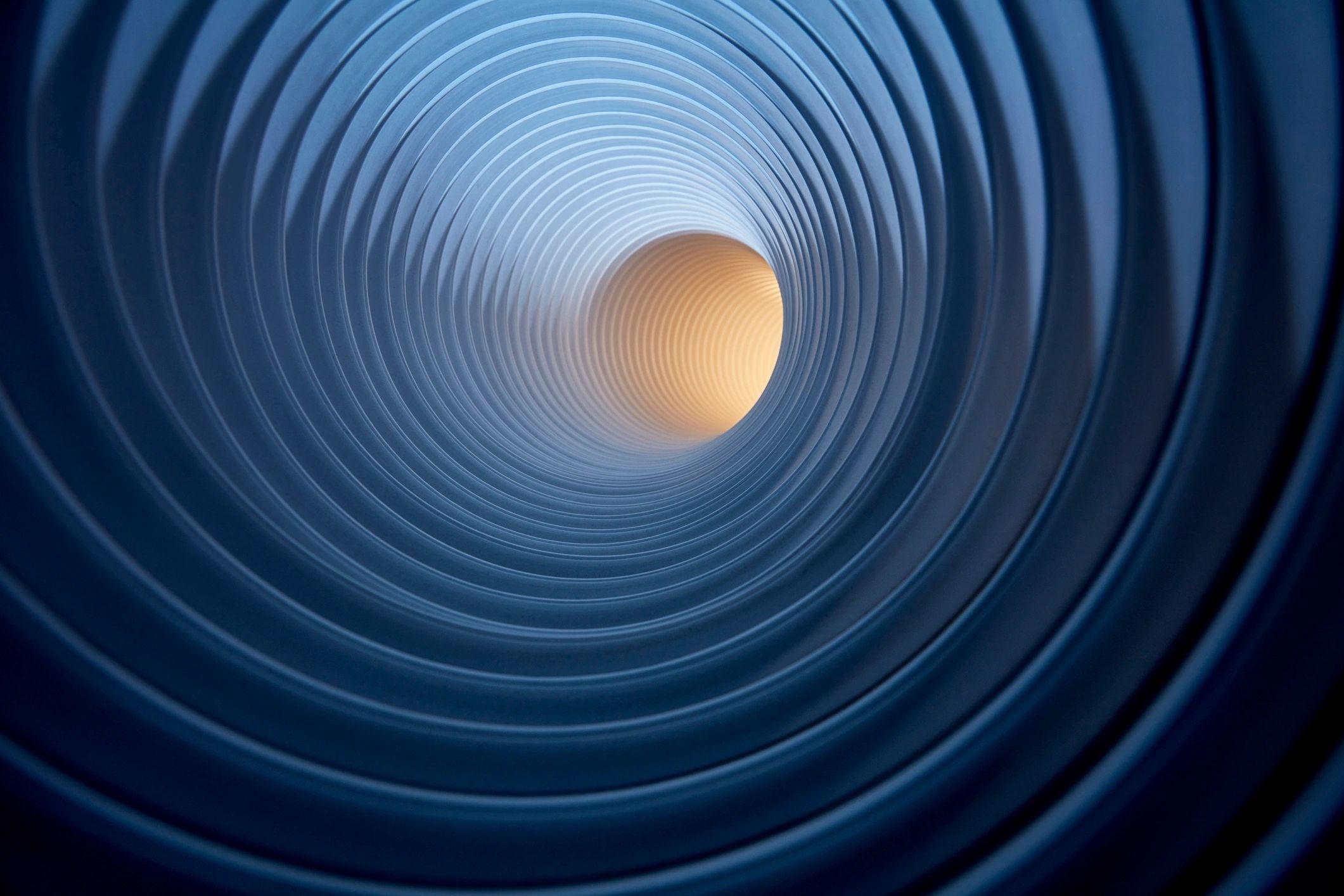 Blue tunnel with light at the end representing forward momentum and direction